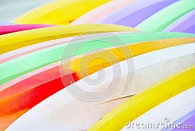 Detail of two rows of colorful stacked surfboards Stock Photo