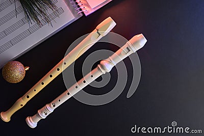Two traditional plastic recorder on black table for Christmas event Stock Photo