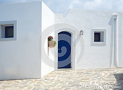 Detail of a typical greek building with white walls and blue door Stock Photo
