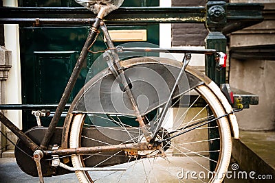 Detail of vintage old rusty bicycle parked in front of Dutch house Stock Photo