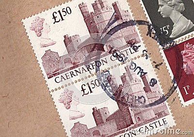 Detail of vintage Uk postage stamps on a brown envelope. Editorial Stock Photo
