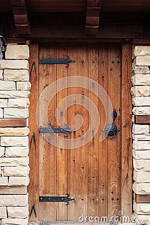 Detail of vintage wooden door, stone wall Stock Photo