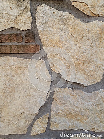 Detail of a wall with stones in various shades of beige. Stock Photo