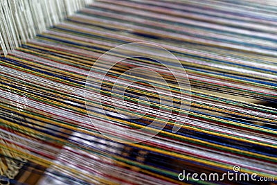 Strings of warp threads in weaving loom close-up Stock Photo