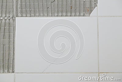 Detail of white cracked tile on the wall Stock Photo