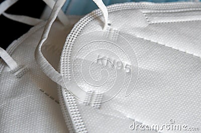 Detail of white KN95 or N95 mask with antiviral medical mask for protection against coronavirus on black background. Stock Photo