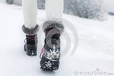 Detail of woman lifting her black and gray snow boot Stock Photo
