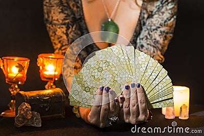 Detail of a woman`s hands showing a deck of tarot cards Stock Photo