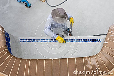 Detail work on new pool plaster amd tile Stock Photo