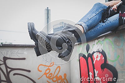 Detail of a young woman wearing biker boots Stock Photo