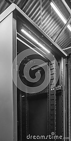 Detailed image of a Computer and Network server cabinet showing the front meshed door open. Editorial Stock Photo