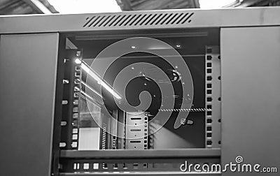 Detailed image of a Computer and Network server cabinet showing the front meshed door open. Editorial Stock Photo
