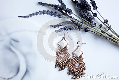 Detailed luxury pair of gold earrings with marble stone Stock Photo