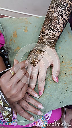 Detailed process of applying intricate pattern Henna on hand Stock Photo