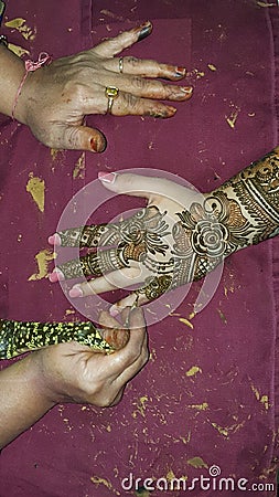 Detailed process of applying intricate pattern Henna on hand Stock Photo