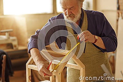 Detailed process of creating wooden feeder Stock Photo