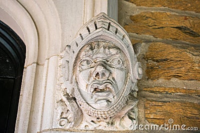 A Detailed Statue of a Face on a Cobblestone Wall at the Elkins Estate Stock Photo