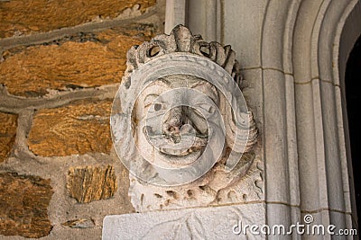 A Detailed Statue of a Face on a Cobblestone Wall at the Elkins Estate Stock Photo