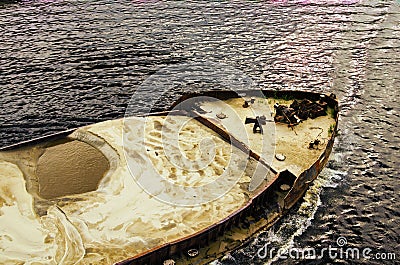 Detailed view of cargo ship barge loaded with sand. Top view of the front of the barge Stock Photo