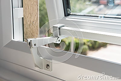 Detailed view of a Hotel window metal hinged system, seen in the maximum, opened position. Stock Photo