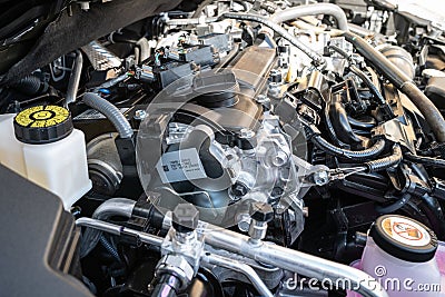 Detailed view of a newly built, Japanese-made hybrid engine showing the intricate pipework and cables. Editorial Stock Photo