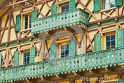 Detailed view of a traditional Bavarian house with half-timbered house and green balconies made of wood Stock Photo