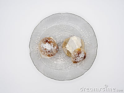 Detailed view of traditional Swedish semla, or fastlagsbulle, with whipped cream, almond paste and confectioners' sugar. Stock Photo