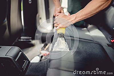 detailing and car care concept - Professional using steam vacuum for draining stains Stock Photo