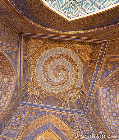 Blue interior of dome with gold gild of Tile Karl Madrasa in The Stock Photo