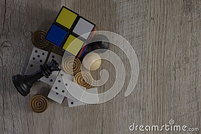 Details of board games, dominoes, dice, chess on a light and wooden background. Stock Photo