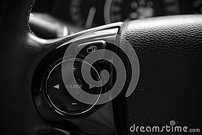 Details of controller bottons on steering wheel of modern car Stock Photo