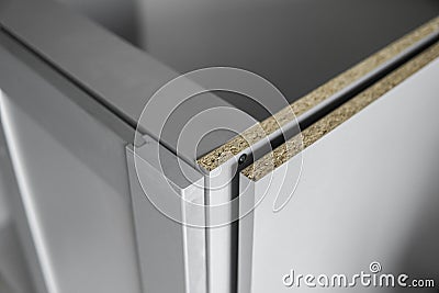 Details of custom kitchen cabinets of the gray modular kitchen from chipboard material on a various stages of Stock Photo