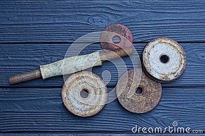 details of a disassembled gray brown old sports iron dumbbell Stock Photo