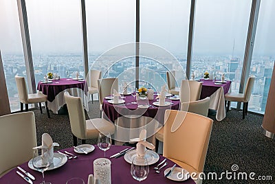 Details of elegant indoor restaurant tables with city View. Ho C Editorial Stock Photo