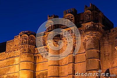 Details of Jodhpur fort illuminated at twilight. The majestic fort perched on top dominating the blue town. Scenic travel destina Stock Photo