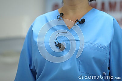 Details with many lavalier microphones on the medical coat of a woman medic Stock Photo