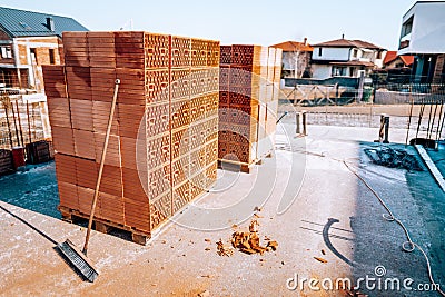 Details of modern bricks on construction site. Piles of bricks on concrete slab Stock Photo