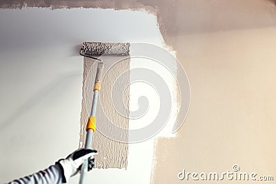 Details of painting walls, industrial worker using roller and other tools for painting walls Stock Photo