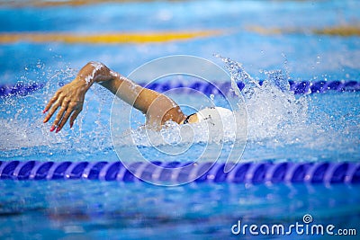 Details with a professional female athlete swimming in an olympic swimming pool Editorial Stock Photo