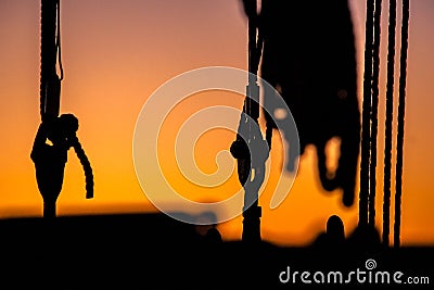 Details and silhouettes of an old sailing ship at sunset Stock Photo