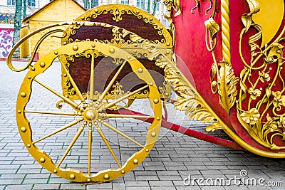 Details, wheels, structure and ornaments of forged iron carriage. Floral decorative ornament, made from metal. Vintage metallic pa Stock Photo