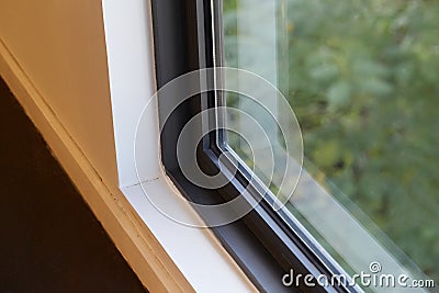 Details of windows temperature glass with matte black aluminum frame. Stock Photo