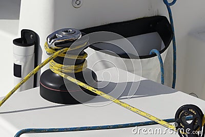 Details of yellow genoa sheet secured on self-tailing winch on sailing boat racer, boating concept Stock Photo