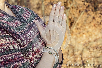 Detal of woman doing namaste hand mudra pose Stock Photo