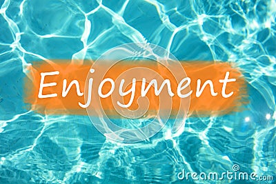 Detal of word `Enjoyment` on swimming pool water and sun reflecting on the surface Stock Photo