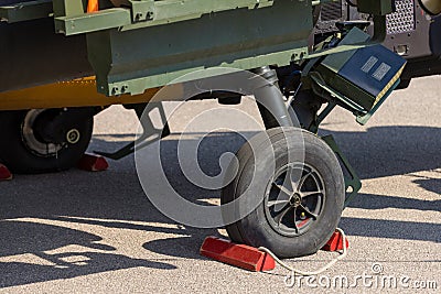 Detail of a landing gear with aircraft thrust pad of combat helicopter on apron Stock Photo