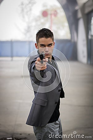 Detective or mobster or policeman aiming a firearm Stock Photo