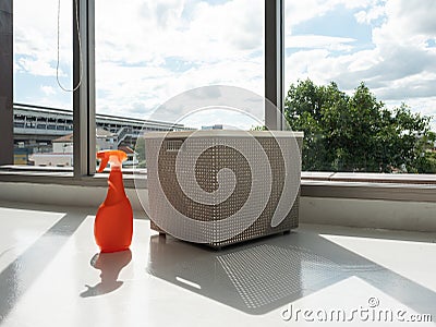 Detergent bottle mock up for clean fabric with clothing basket on the floor indoor with sun light and cloud sky Stock Photo