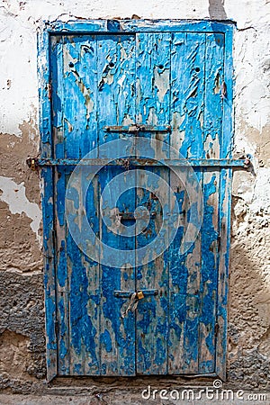 Deteriorating Old Blue Door in Essaouira Morocco Stock Photo