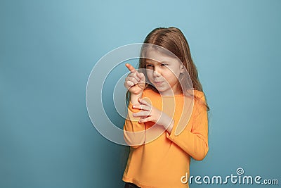 The determination. Teen girl on a blue background. Facial expressions and people emotions concept Stock Photo